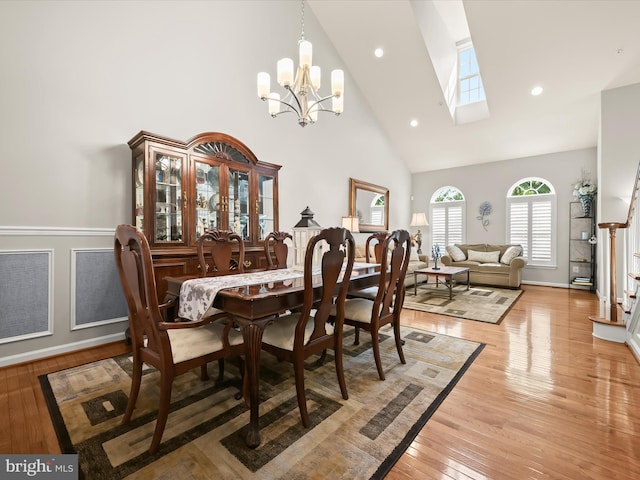 5910 Constance Way, New Market, MD 21774 - dining room featuring high vaulted ceiling, a skylight, a chandelier, light wood-style flooring, and recessed lighting