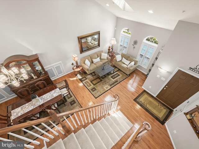 5910 Constance Way, New Market, MD 21774 - living area featuring a high ceiling, wood finished floors, a skylight, stairway, and recessed lighting