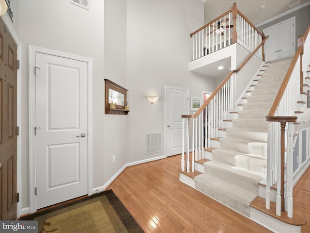 5910 Constance Way, New Market, MD 21774 - entryway with wood finished floors, a towering ceiling, stairs, and crown molding