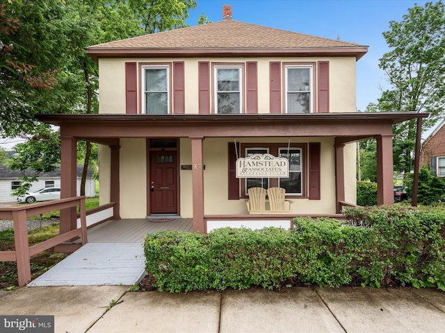 507 S Fairfax Blvd, Charles Town, WV 25414 - view of front facade featuring covered porch, stucco siding, and a chimney