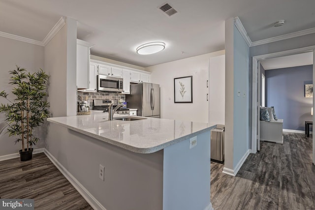 20408 Shore Harbour Dr Unit 5-C, Germantown, MD 20874 - kitchen with appliances with stainless steel finishes, dark wood-type flooring, a peninsula, light stone countertops, and white cabinetry