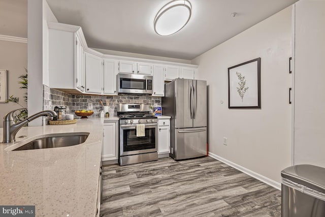 20408 Shore Harbour Dr Unit 5-C, Germantown, MD 20874 - kitchen with stainless steel appliances, white cabinetry, light stone countertops, wood finished floors, and tasteful backsplash