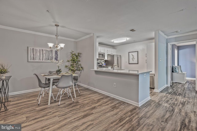 20408 Shore Harbour Dr Unit 5-C, Germantown, MD 20874 - dining space featuring dark wood-style flooring, ornamental molding, and a chandelier