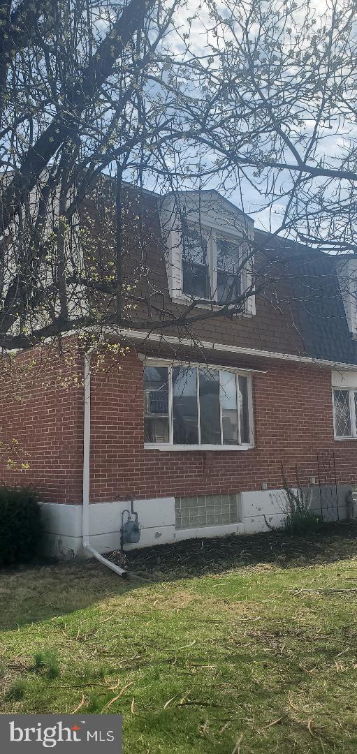 200 Baldwin Ave, Ridley Park, PA 19078 - view of home's exterior featuring brick siding, a yard, roof with shingles, and crawl space