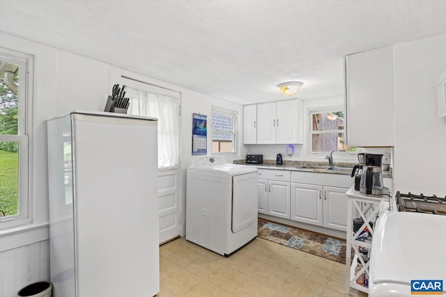 614N Commerce St, Culpeper, VA 22701 - laundry area with washer / clothes dryer, light flooring, plenty of natural light, and a textured ceiling