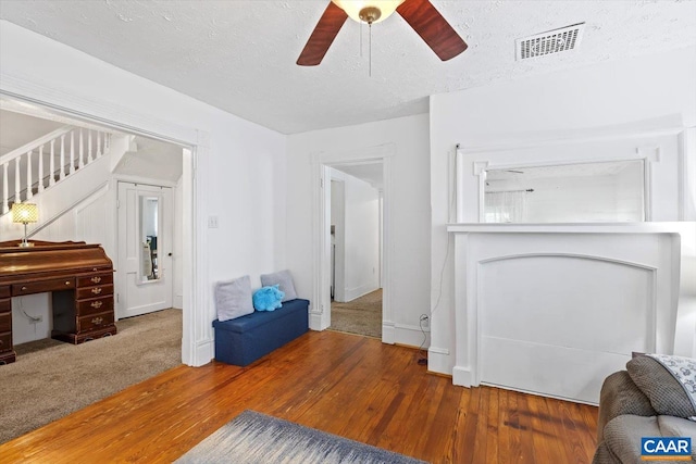 614N Commerce St, Culpeper, VA 22701 - unfurnished living room featuring wood finished floors, ceiling fan, a textured ceiling, and stairway