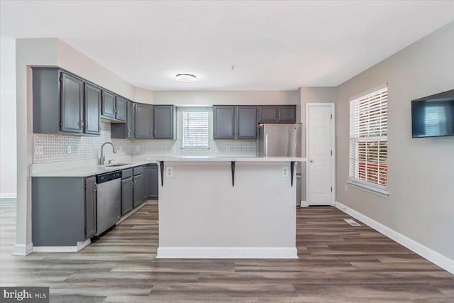 6116 Baldridge Ter, Frederick, MD 21701 - kitchen with stainless steel appliances, a kitchen island, light countertops, and tasteful backsplash