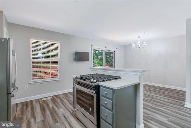 6116 Baldridge Ter, Frederick, MD 21701 - kitchen with stainless steel appliances, gray cabinets, light wood finished floors, and light countertops