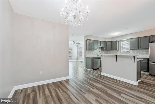 6116 Baldridge Ter, Frederick, MD 21701 - kitchen featuring stainless steel appliances, light countertops, wood finished floors, and gray cabinets