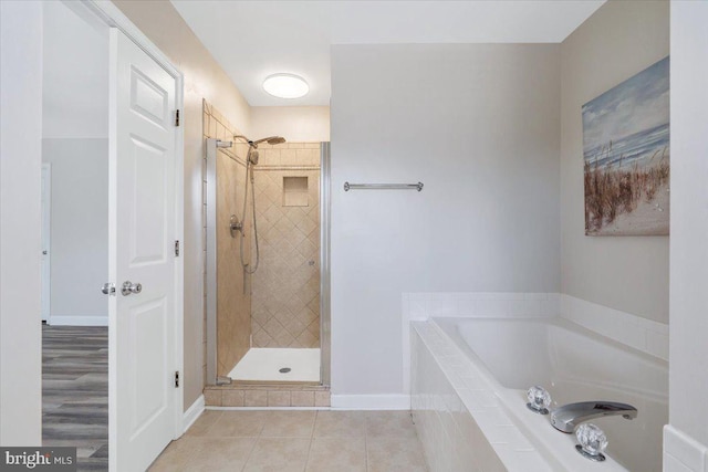 6116 Baldridge Ter, Frederick, MD 21701 - full bathroom with a bath, a shower stall, and tile patterned flooring