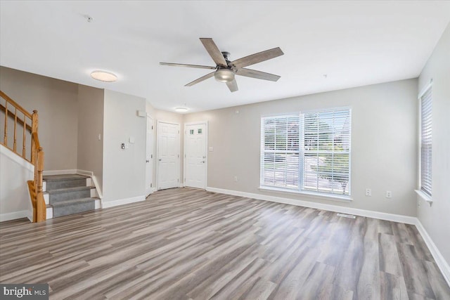 6116 Baldridge Ter, Frederick, MD 21701 - unfurnished living room featuring stairway, wood finished floors, and a ceiling fan