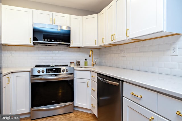 14 Haddonfield Cmns Unit 14, Haddonfield, NJ 08033 - kitchen with stainless steel appliances, white cabinets, and tasteful backsplash