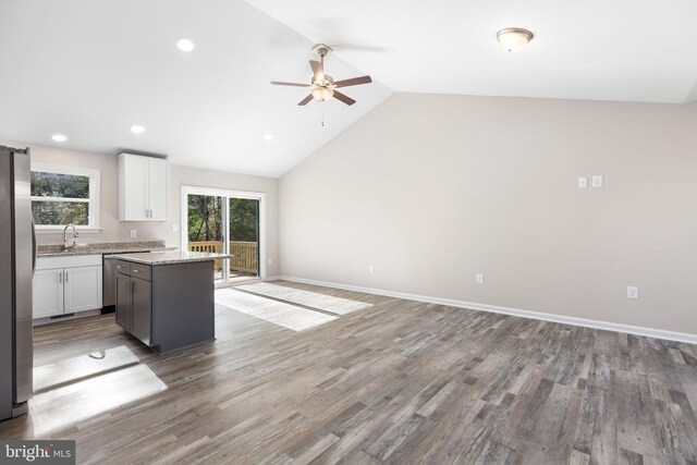 916 Lakeview Dr, Colonial Beach, VA 22443 - kitchen featuring a ceiling fan, stainless steel appliances, a kitchen island, white cabinetry, and lofted ceiling