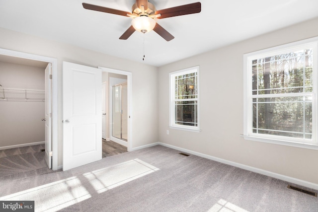 916 Lakeview Dr, Colonial Beach, VA 22443 - unfurnished bedroom with carpet flooring, a spacious closet, a closet, and a ceiling fan