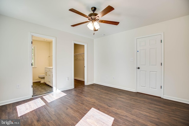916 Lakeview Dr, Colonial Beach, VA 22443 - unfurnished bedroom featuring dark wood-style floors, a spacious closet, a closet, ensuite bath, and ceiling fan