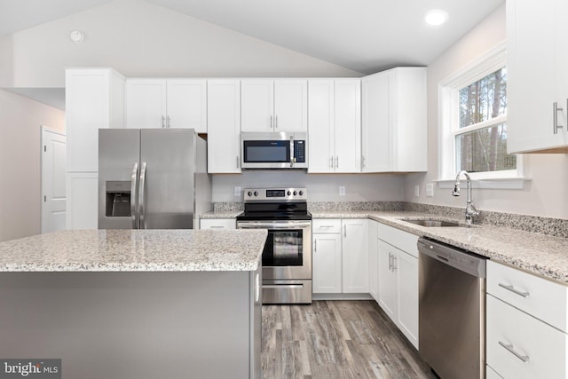 916 Lakeview Dr, Colonial Beach, VA 22443 - kitchen with appliances with stainless steel finishes, lofted ceiling, light wood-style flooring, white cabinets, and recessed lighting