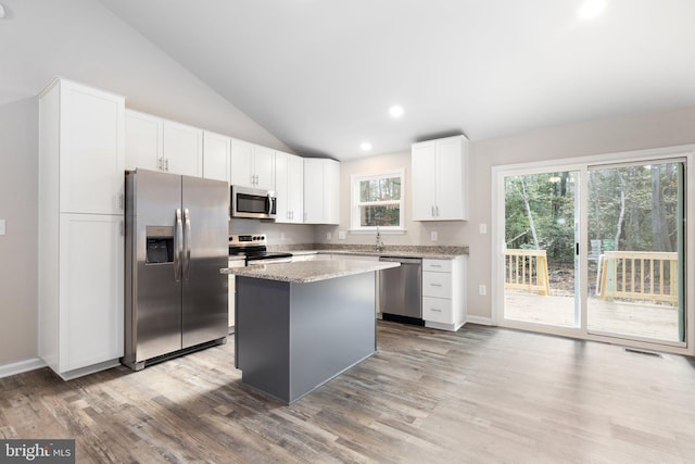 916 Lakeview Dr, Colonial Beach, VA 22443 - kitchen with appliances with stainless steel finishes, vaulted ceiling, light wood finished floors, a center island, and healthy amount of natural light