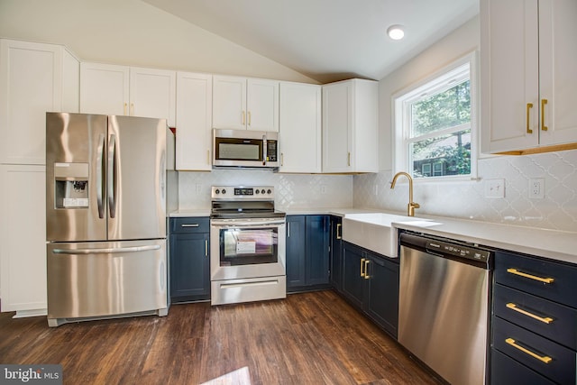 916 Lakeview Dr, Colonial Beach, VA 22443 - kitchen featuring stainless steel appliances, blue cabinetry, lofted ceiling, white cabinets, and light countertops