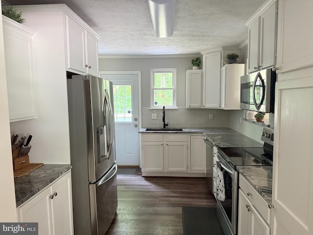 4123 Cassell Blvd, Prince Frederick, MD 20678 - kitchen with stainless steel appliances, dark wood-style flooring, white cabinets, tasteful backsplash, and a textured ceiling