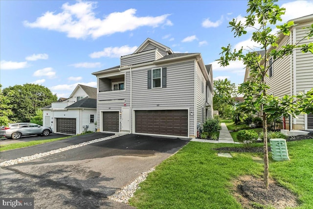 519 S Media Way, Media, PA 19063 - view of property with asphalt driveway, a garage, and a front yard