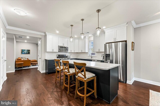 519 S Media Way, Media, PA 19063 - kitchen with stainless steel appliances, light countertops, a center island, crown molding, and white cabinetry