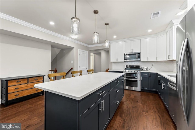 519 S Media Way, Media, PA 19063 - kitchen featuring stainless steel appliances, white cabinets, light countertops, crown molding, and a kitchen island