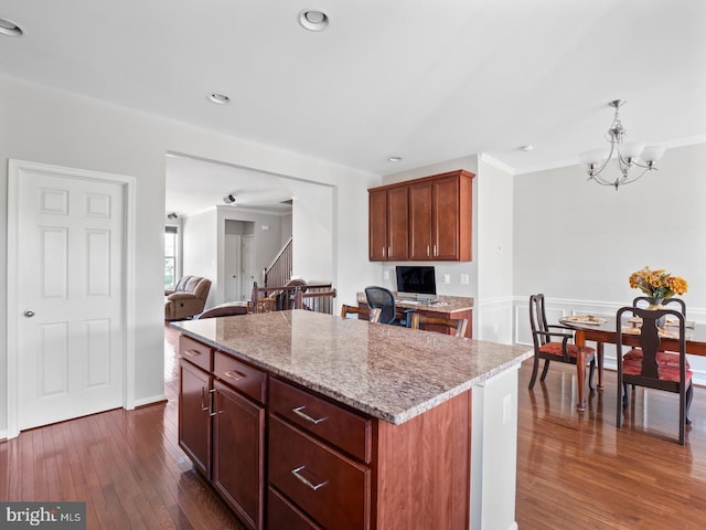 24847 Mason Dale Ter, Chantilly, VA 20152 - kitchen with a kitchen island, dark wood finished floors, a chandelier, light stone countertops, and hanging light fixtures