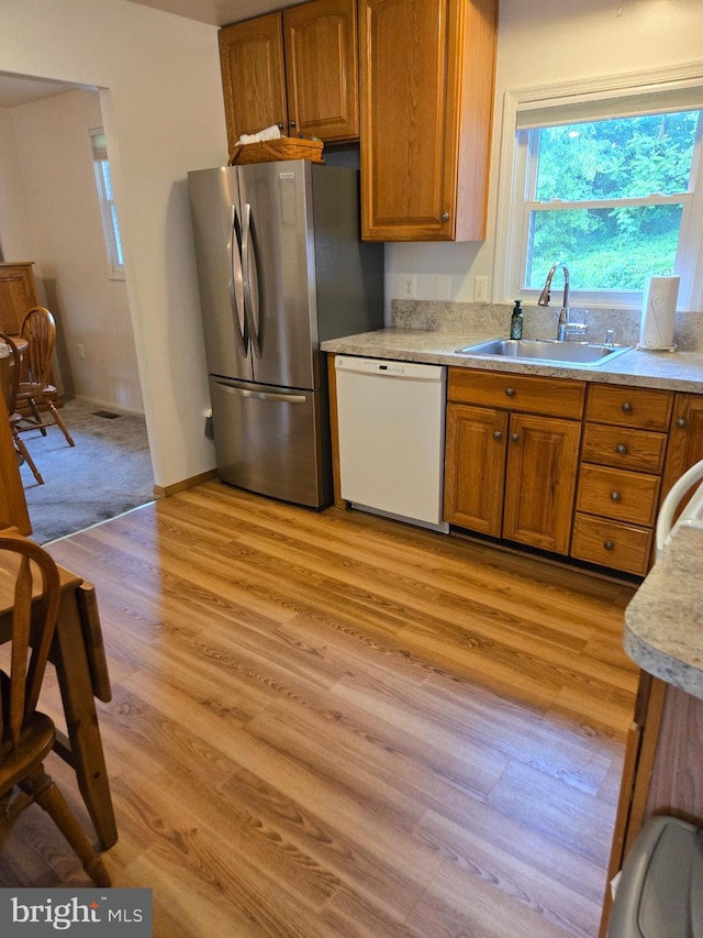 3277 Sudlersville S, Laurel, MD 20724 - kitchen featuring white dishwasher, freestanding refrigerator, brown cabinetry, light wood-type flooring, and light countertops