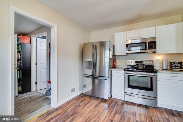 104 W Hawthorne Dr, La Plata, MD 20646 - kitchen featuring appliances with stainless steel finishes, dark wood-style flooring, white cabinetry, and light stone countertops
