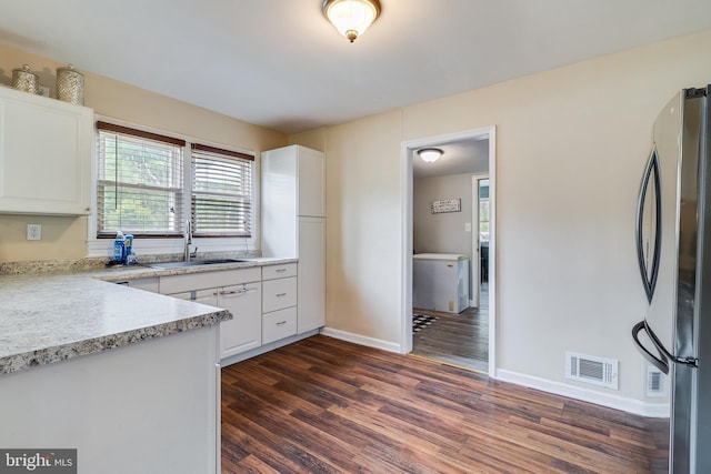 104 W Hawthorne Dr, La Plata, MD 20646 - kitchen with freestanding refrigerator, dark wood-type flooring, white cabinets, and light countertops