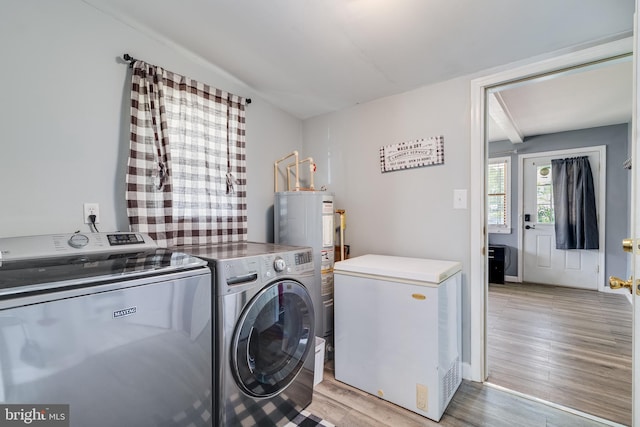 104 W Hawthorne Dr, La Plata, MD 20646 - washroom featuring washer and clothes dryer, light wood finished floors, and water heater
