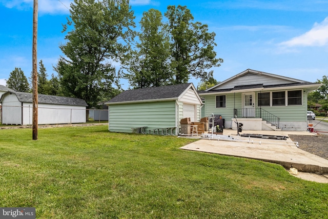 104 W Hawthorne Dr, La Plata, MD 20646 - rear view of property with an outbuilding, a patio, a lawn, and a garage
