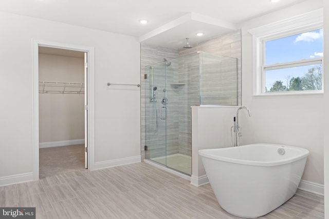 121 Lillian Ct, Fredericksburg, VA 22406 - full bathroom featuring a shower stall, a soaking tub, a spacious closet, and recessed lighting