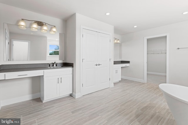 121 Lillian Ct, Fredericksburg, VA 22406 - full bathroom with vanity, a soaking tub, wood finished floors, recessed lighting, and a walk in closet