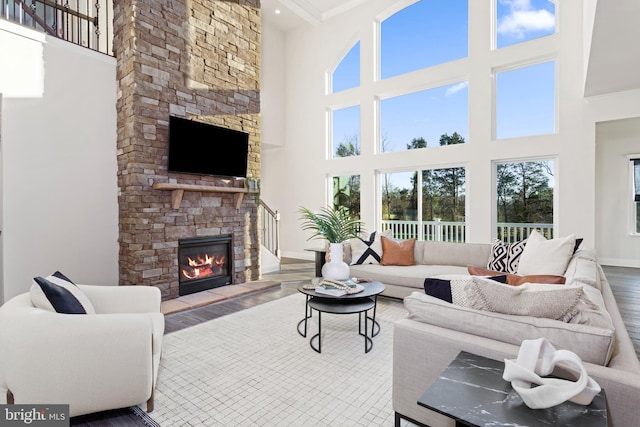 121 Lillian Ct, Fredericksburg, VA 22406 - living room featuring a high ceiling, a stone fireplace, wood finished floors, and ornamental molding