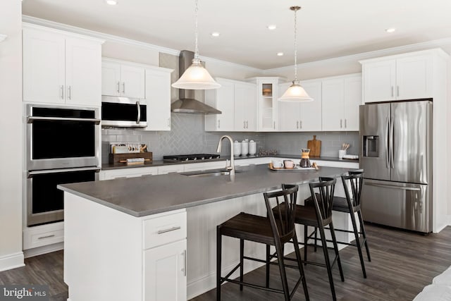 121 Lillian Ct, Fredericksburg, VA 22406 - kitchen featuring stainless steel appliances, dark wood-style flooring, backsplash, wall chimney range hood, and white cabinetry