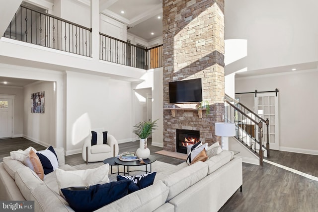 121 Lillian Ct, Fredericksburg, VA 22406 - living room with a high ceiling, a stone fireplace, wood finished floors, ornamental molding, and recessed lighting