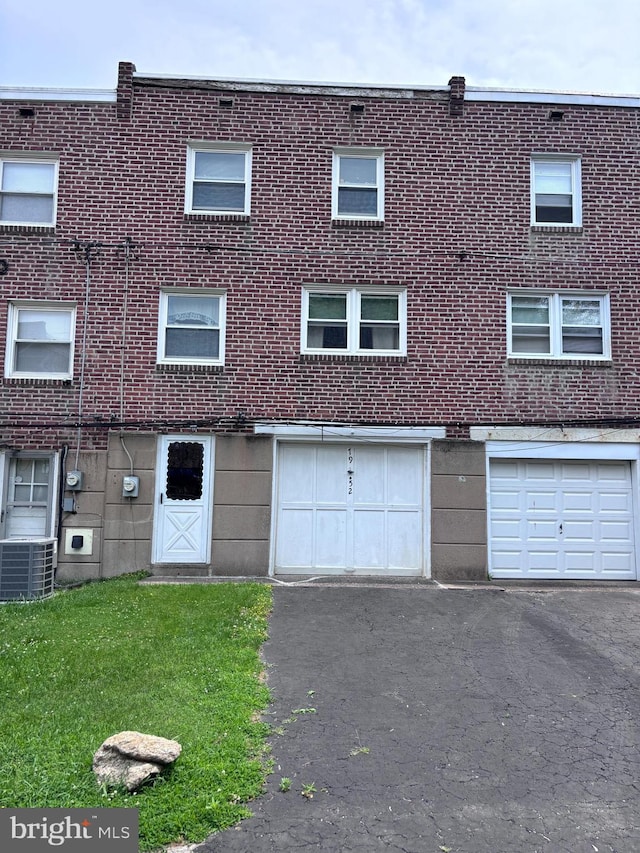 7952 Arlington Ave, Upper Darby, PA 19082 - view of building exterior featuring driveway and a garage