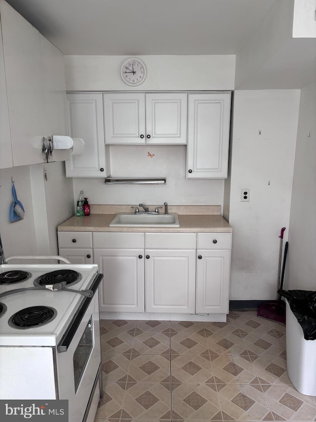 7952 Arlington Ave, Upper Darby, PA 19082 - kitchen with electric stove, white cabinets, and light countertops