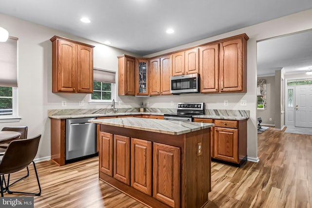5 Fisher Ct, Sewell, NJ 08080 - kitchen with appliances with stainless steel finishes, light wood-style floors, light countertops, glass insert cabinets, and brown cabinets