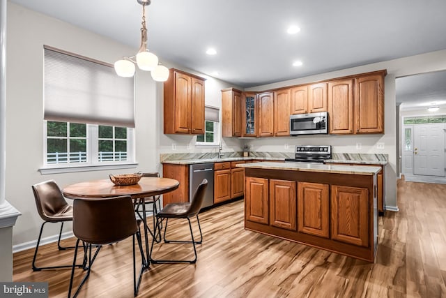 5 Fisher Ct, Sewell, NJ 08080 - kitchen featuring appliances with stainless steel finishes, light wood-type flooring, light countertops, a center island, and brown cabinetry