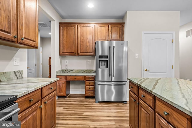 5 Fisher Ct, Sewell, NJ 08080 - kitchen featuring appliances with stainless steel finishes, light wood-style floors, light stone countertops, brown cabinets, and recessed lighting