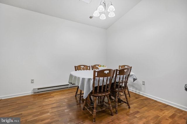 28 Abbey Ct, Carlisle, PA 17015 - dining space featuring baseboard heating, a chandelier, vaulted ceiling, and wood finished floors