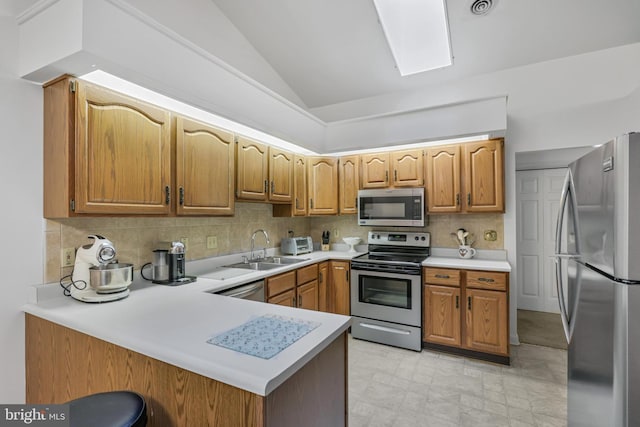 28 Abbey Ct, Carlisle, PA 17015 - kitchen featuring stainless steel appliances, lofted ceiling, a peninsula, light countertops, and tasteful backsplash