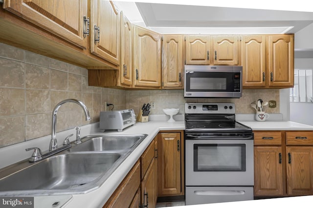 28 Abbey Ct, Carlisle, PA 17015 - kitchen with appliances with stainless steel finishes, backsplash, light countertops, and brown cabinetry