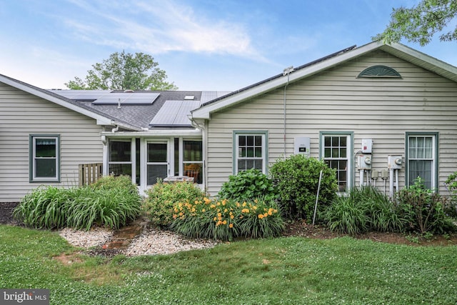 28 Abbey Ct, Carlisle, PA 17015 - rear view of house with solar panels, a lawn, a sunroom, and a shingled roof