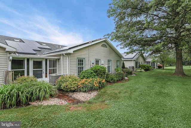 28 Abbey Ct, Carlisle, PA 17015 - view of side of property featuring solar panels, a yard, and roof with shingles