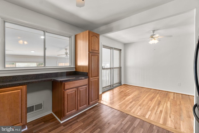 1028 Marleigh Cir, Baltimore, MD 21204 - kitchen featuring ceiling fan, healthy amount of natural light, dark wood-style flooring, and brown cabinetry