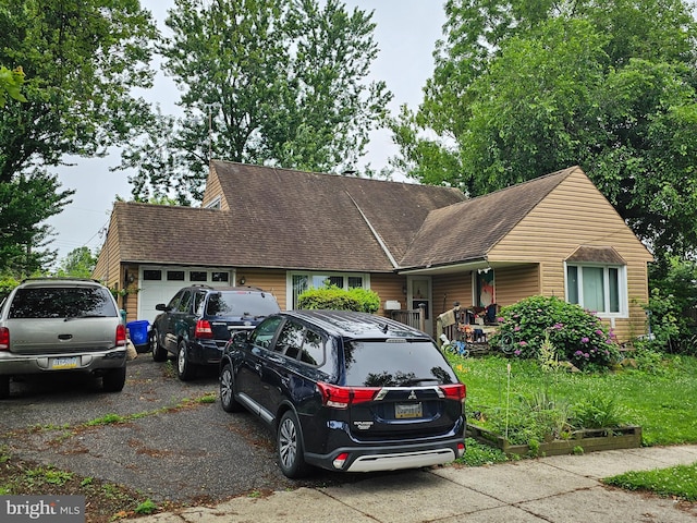 10 Quay Rd, Levittown, PA 19057 - view of front of home with an attached garage, driveway, roof with shingles, and covered porch