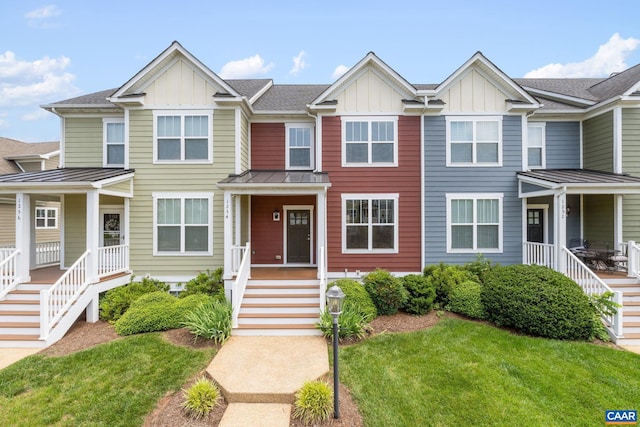 1254 Haden Pl, Crozet, VA 22932 - townhome / multi-family property featuring board and batten siding, a porch, a front yard, and a standing seam roof